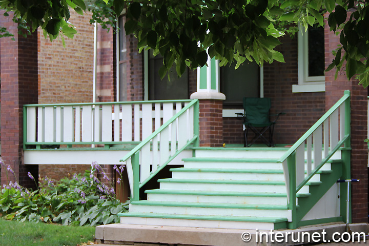 wood front porch combination-of-green-and-white-colors-on-porch