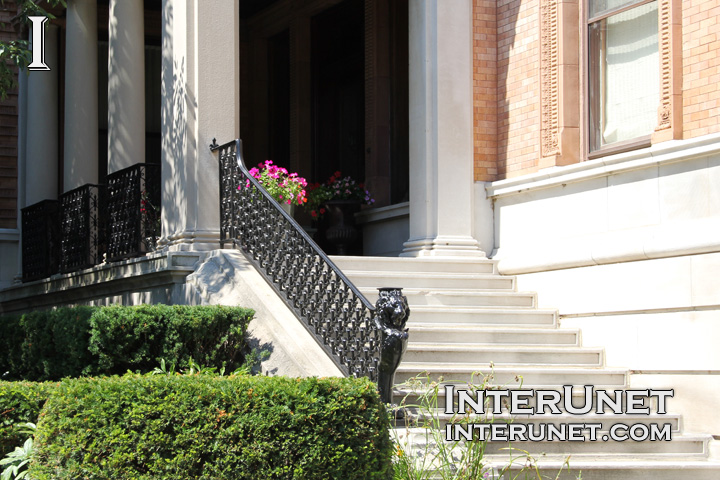 front-porch-with-concrete-steps-and-metal-railing