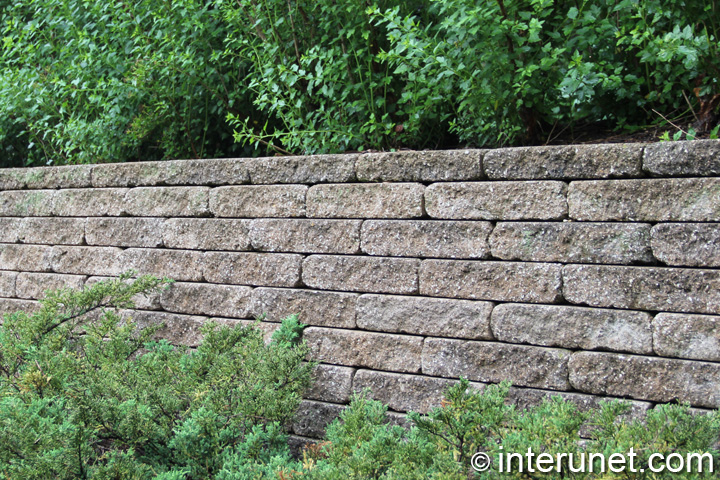 stone blocks fence stone-blocks-fence-with-hedge