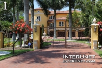 custom-welded-metal-gates-on-yellow-stucco-finished-pillars