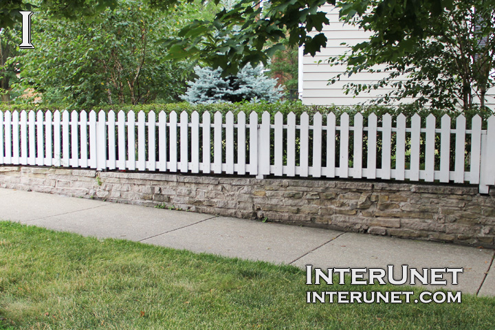 white-picket-fence-on-stone-foundation 