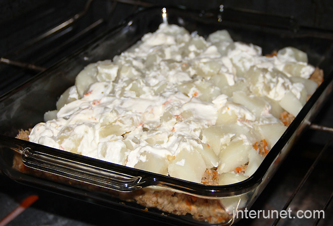 placing-ground-meat-with-potato-and-sour-cream-in-the-oven