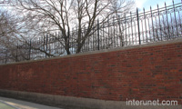 brick-wall-with-metal-fence-on-top