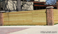 fence-with-brick-pillars-and-horizontal-wood-boards