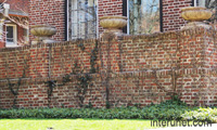 stylish-brick-fence-with-concrete-pots-for-flowers